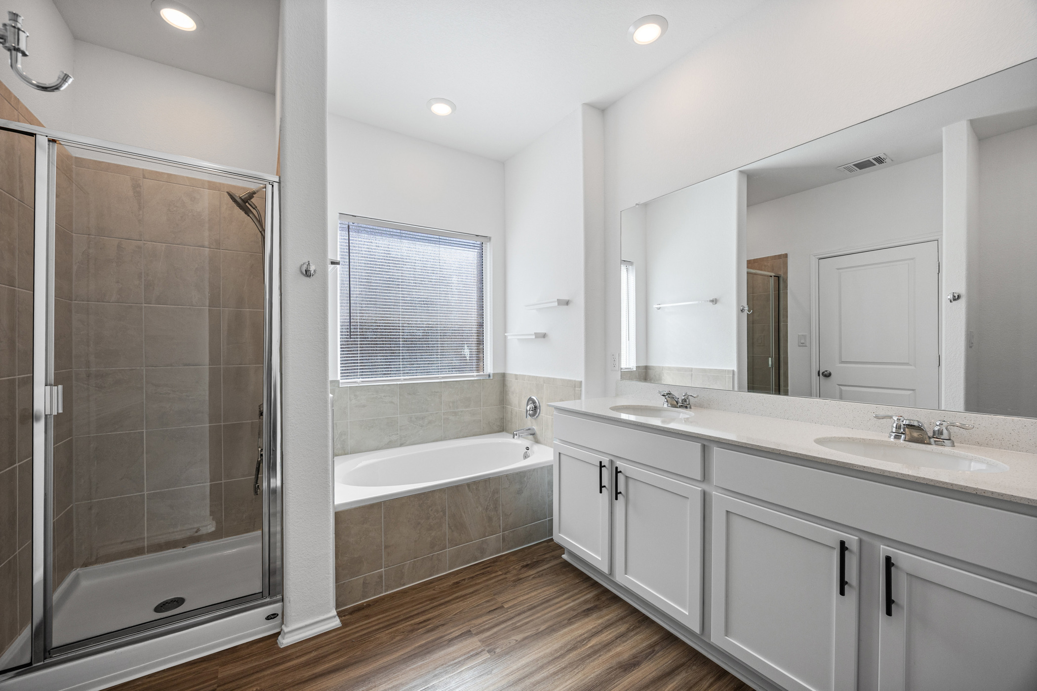 1609 Woolsey Way Leander, TX 78641 - Photo 15 of 29 a bathroom with a tub sink shower and mirror