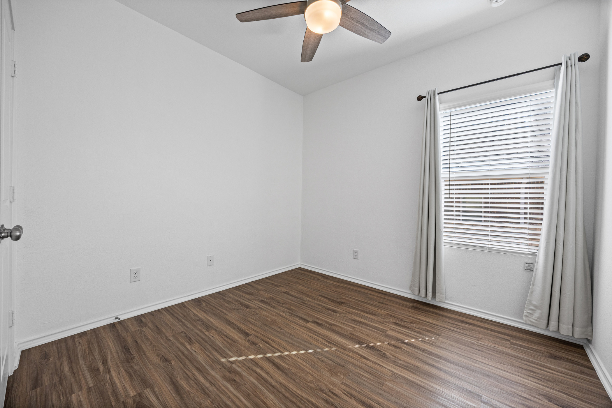 1609 Woolsey Way Leander, TX 78641 - Photo 18 of 29 wooden floor in an empty room with a window