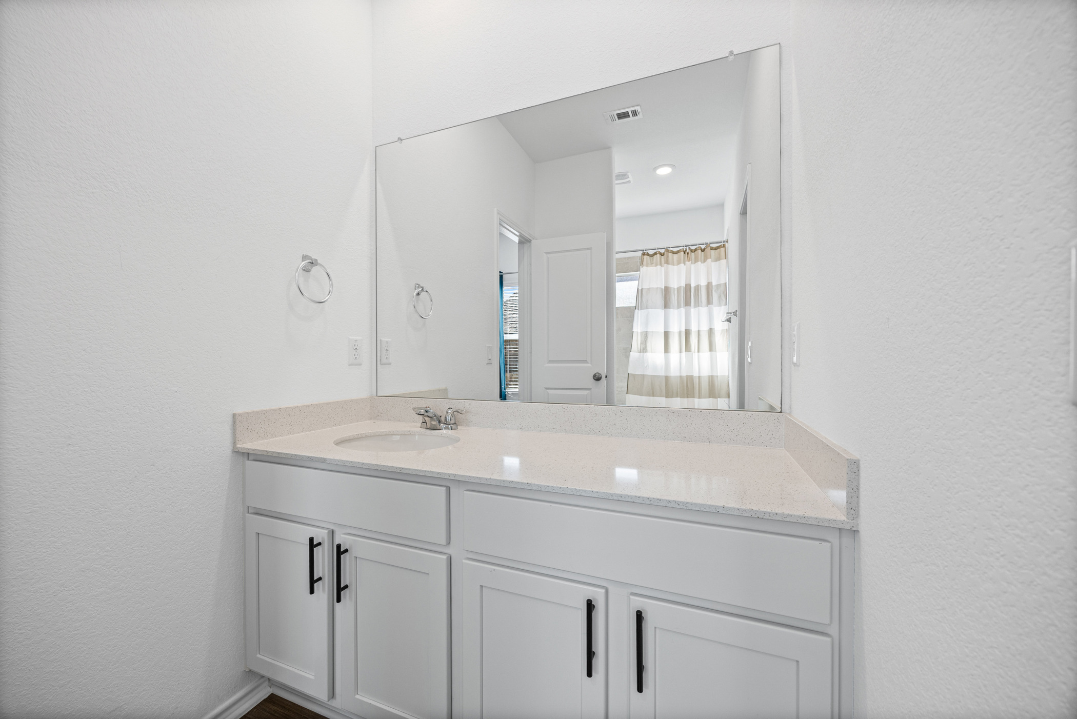 1609 Woolsey Way Leander, TX 78641 - Photo 20 of 29 a bathroom with a sink and a mirror