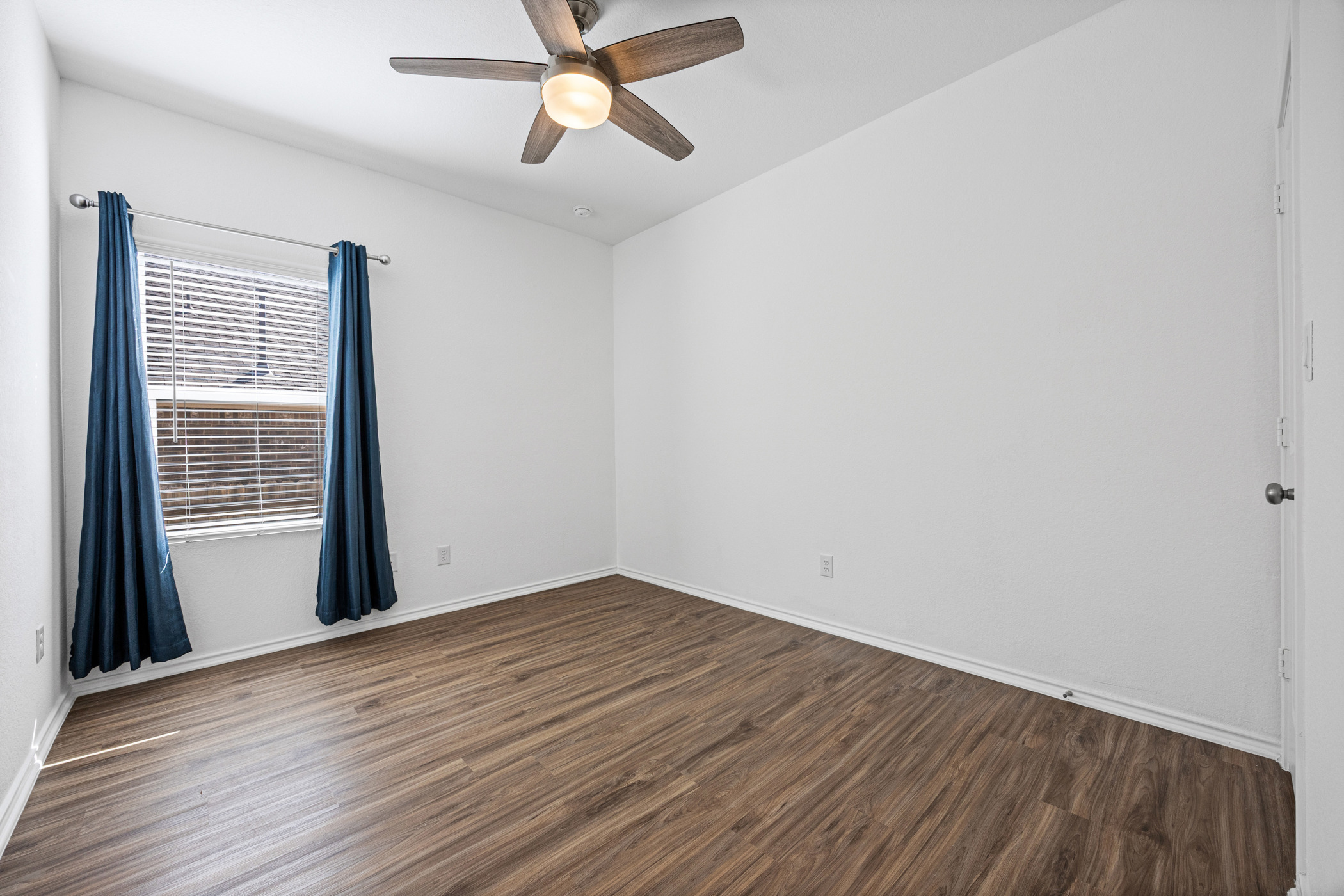 1609 Woolsey Way Leander, TX 78641 - Photo 22 of 29 a view of empty room with wooden floor and fan