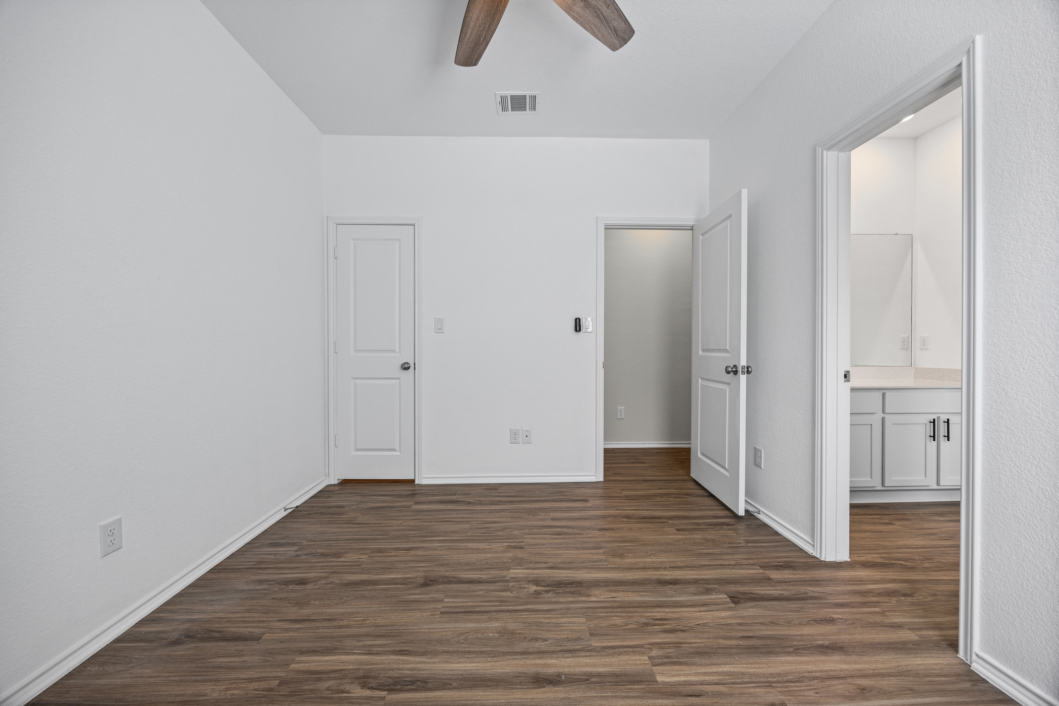 1609 Woolsey Way Leander, TX 78641 - Photo 23 of 29 a view of an empty room with wooden floor