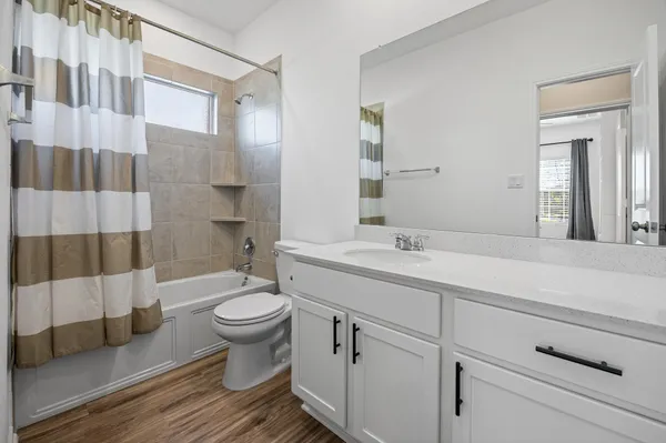 a bathroom with a sink toilet and shower
