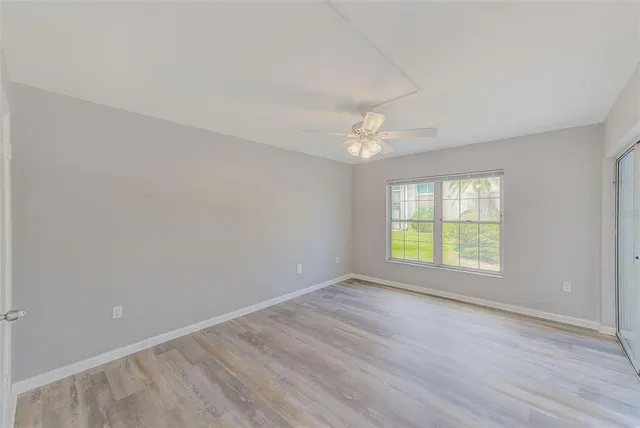 a bedroom with a bed a couch and a window