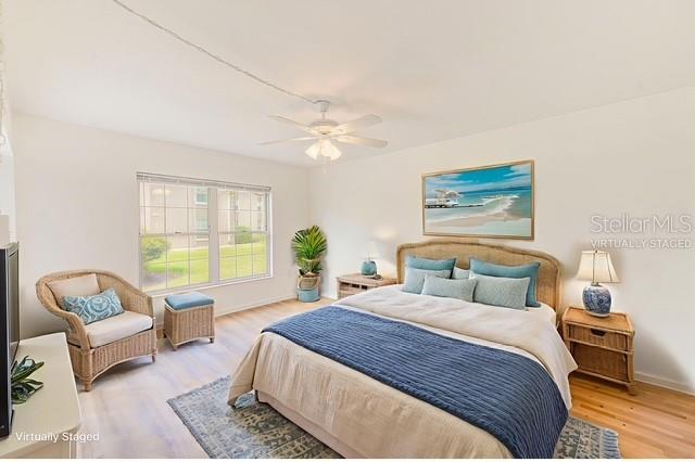 10280 Imperial Point Drive West, Unit 7 Largo, FL 33774 - Photo 35 of 67 a bedroom with a bed a couch and a window