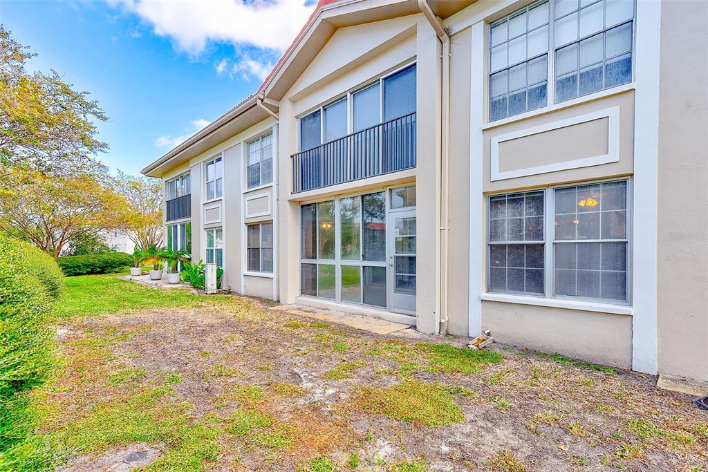 10280 Imperial Point Drive West, Unit 7 Largo, FL 33774 - Photo 41 of 67 a view of a house with a yard and large tree