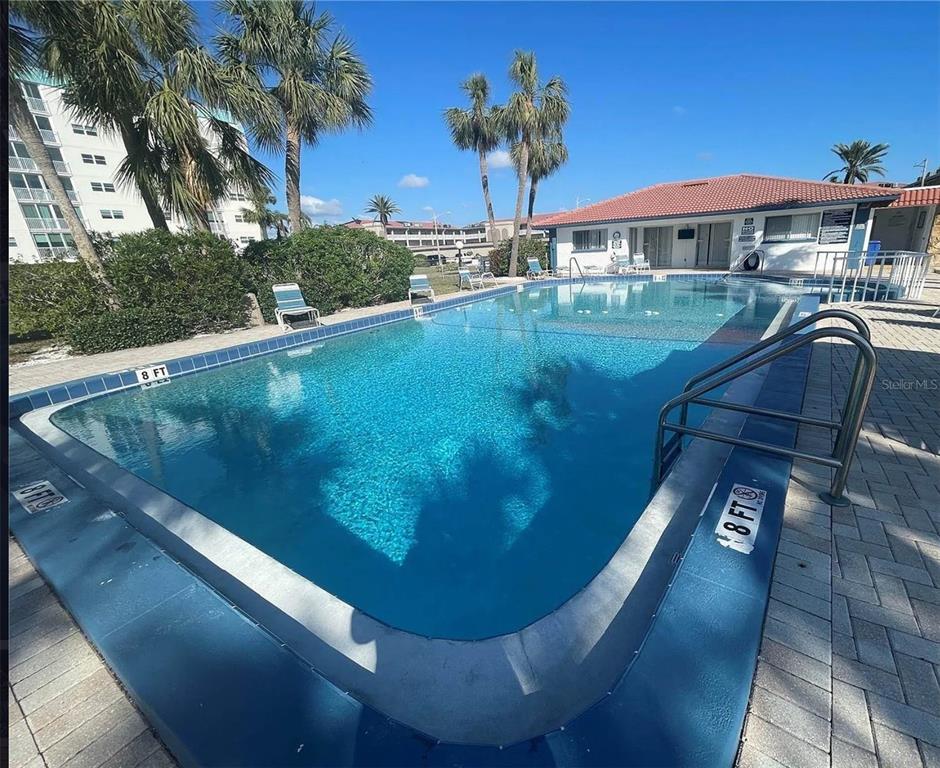 10280 Imperial Point Drive West, Unit 7 Largo, FL 33774 - Photo 50 of 67 a view of a swimming pool with a yard