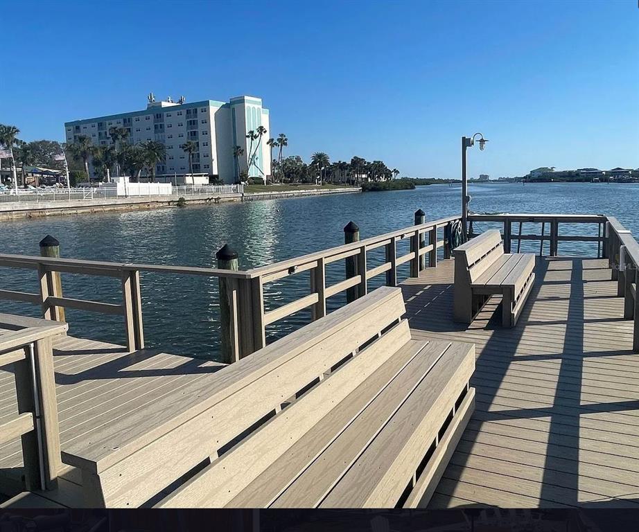 10280 Imperial Point Drive West, Unit 7 Largo, FL 33774 - Photo 58 of 67 a view of a balcony with wooden floor and outdoor seating