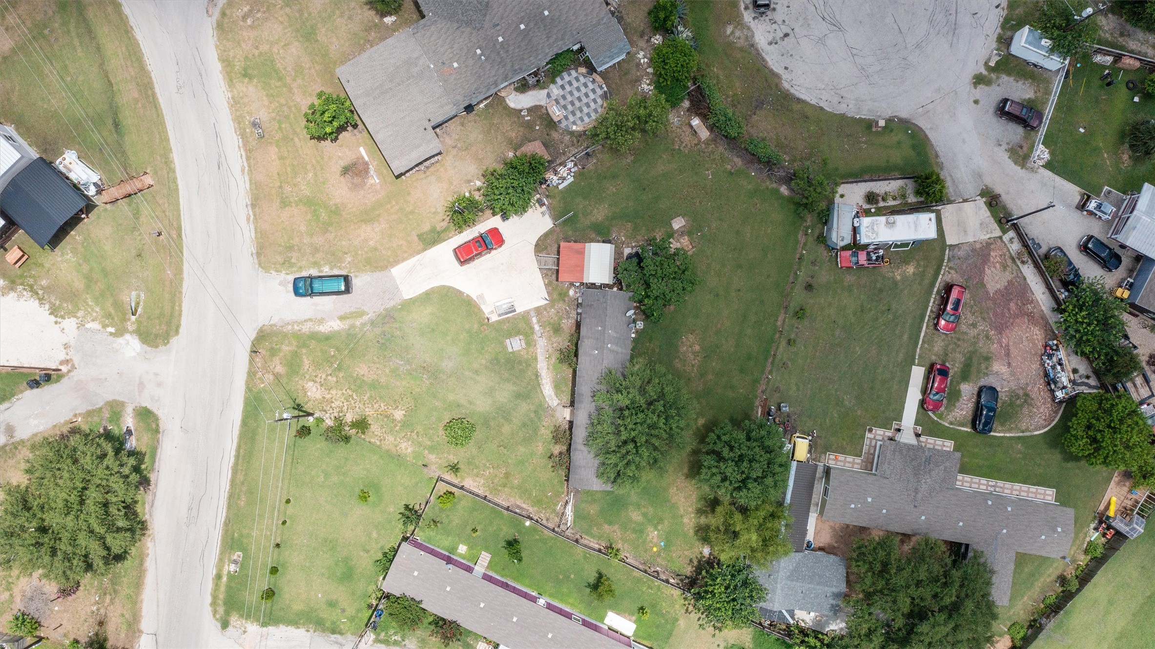 An aerial perspective reveals a residential area with ample green space and paved roads.