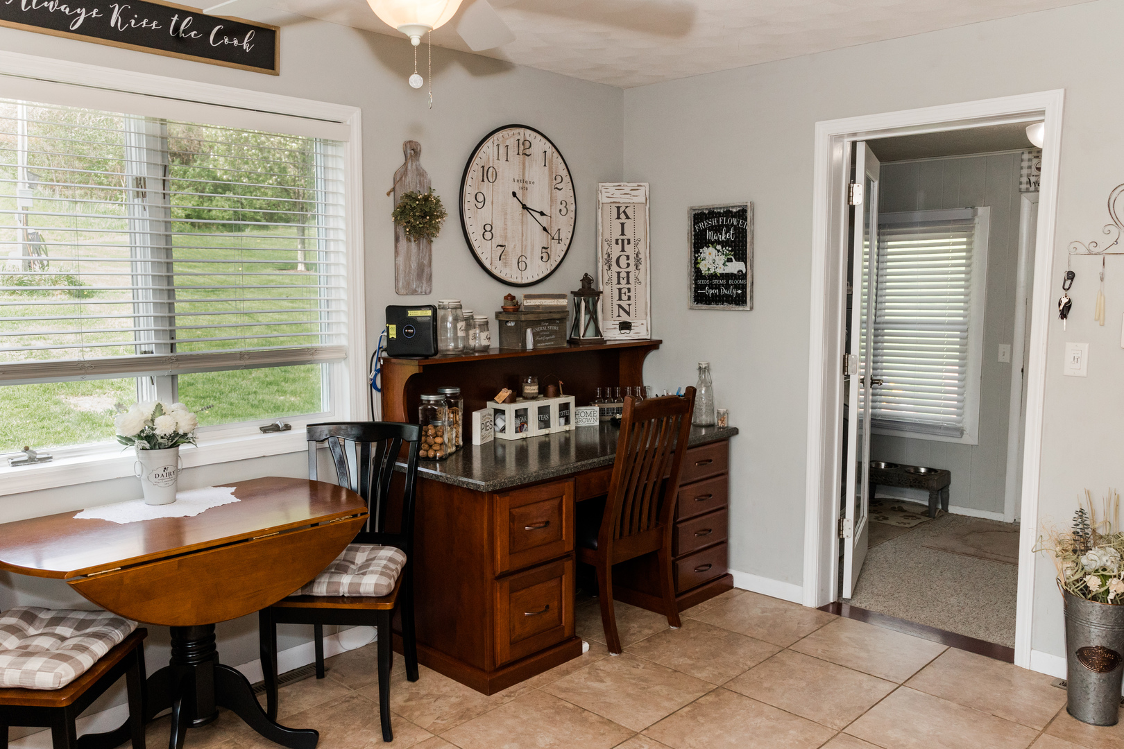 9768 Burns Road Fenton, IL 61251 - Photo 11 of 24 a living room with furniture a clock and a large window