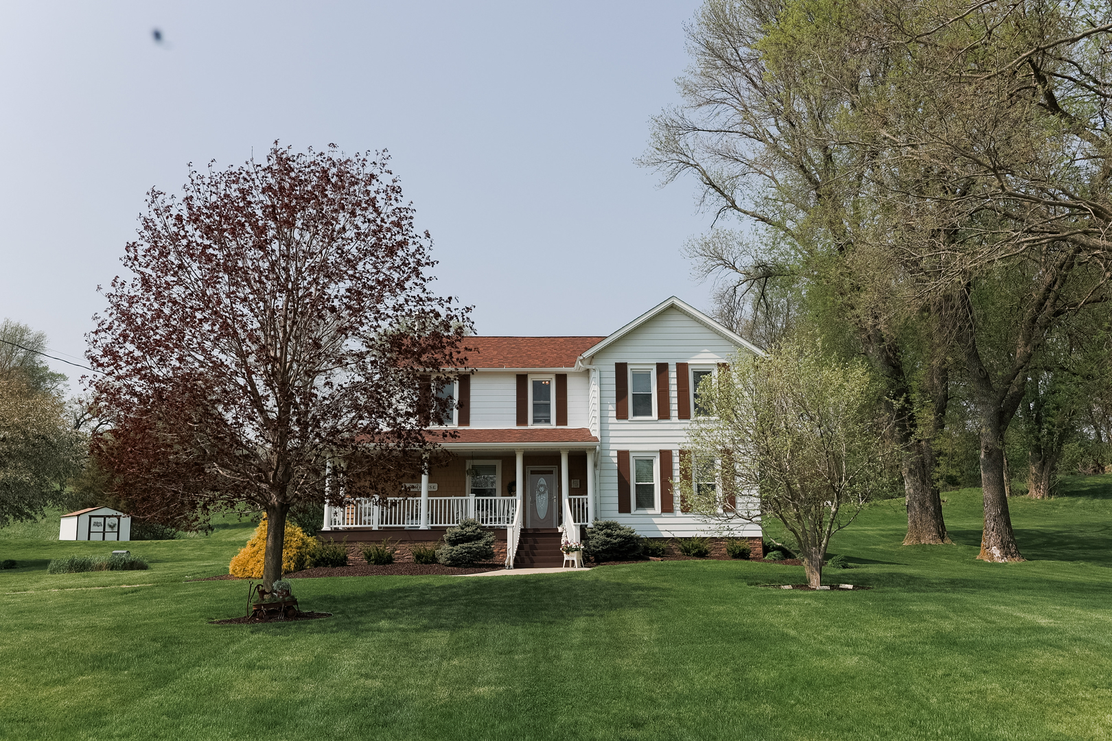 9768 Burns Road Fenton, IL 61251 - Photo 2 of 24 a front view of a house with a garden