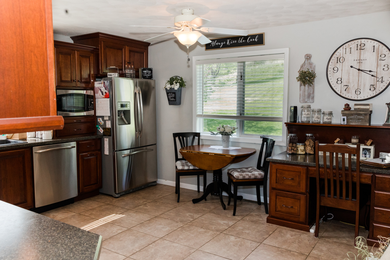 9768 Burns Road Fenton, IL 61251 - Photo 9 of 24 a kitchen with a refrigerator a stove a dining table and chairs
