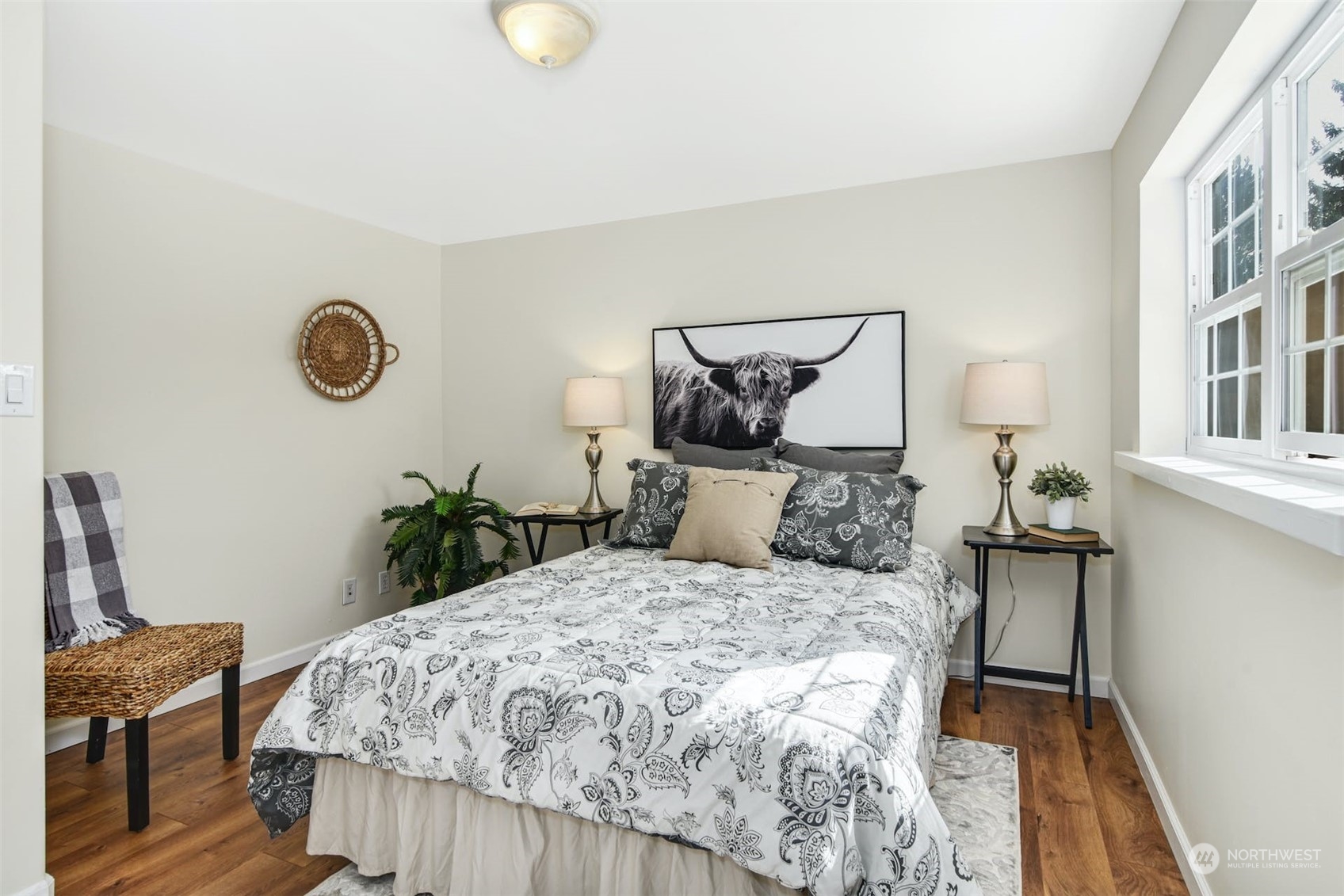 469 Maple Avenue Southwest Renton, WA 98057 - Photo 13 of 30 a bed sitting in a bedroom next to a window and chair