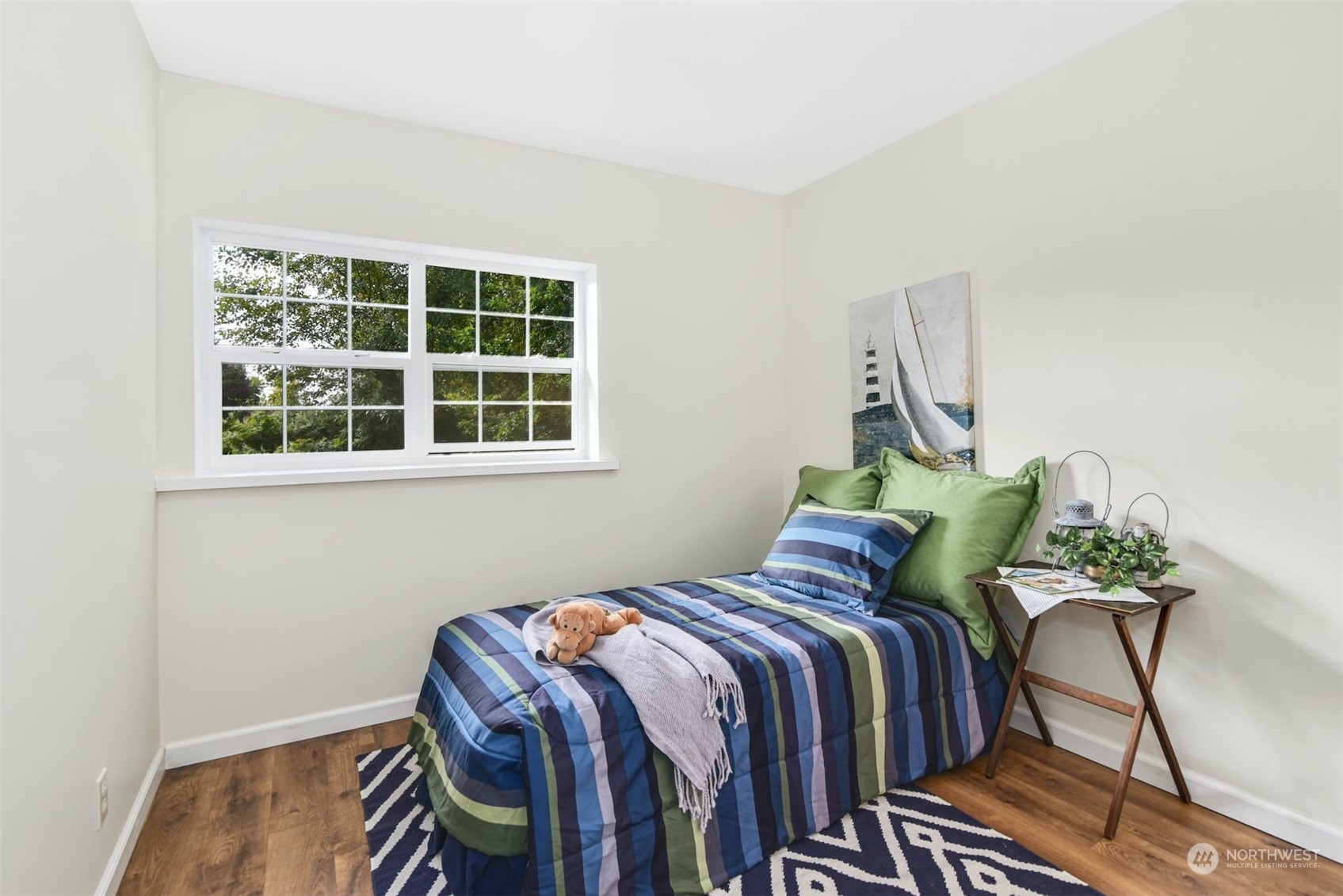 469 Maple Avenue Southwest Renton, WA 98057 - Photo 15 of 30 a bed sitting in a bedroom next to a window