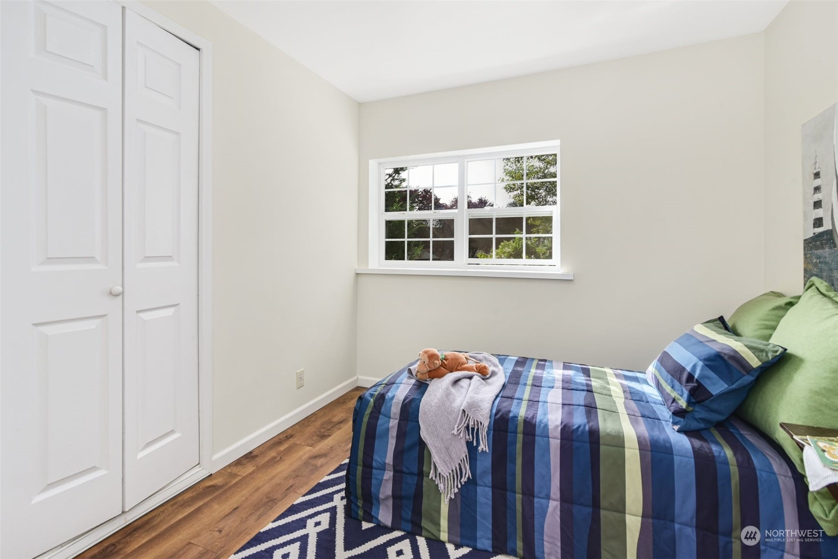 469 Maple Avenue Southwest Renton, WA 98057 - Photo 17 of 30 a bed sitting in a bedroom next to a window