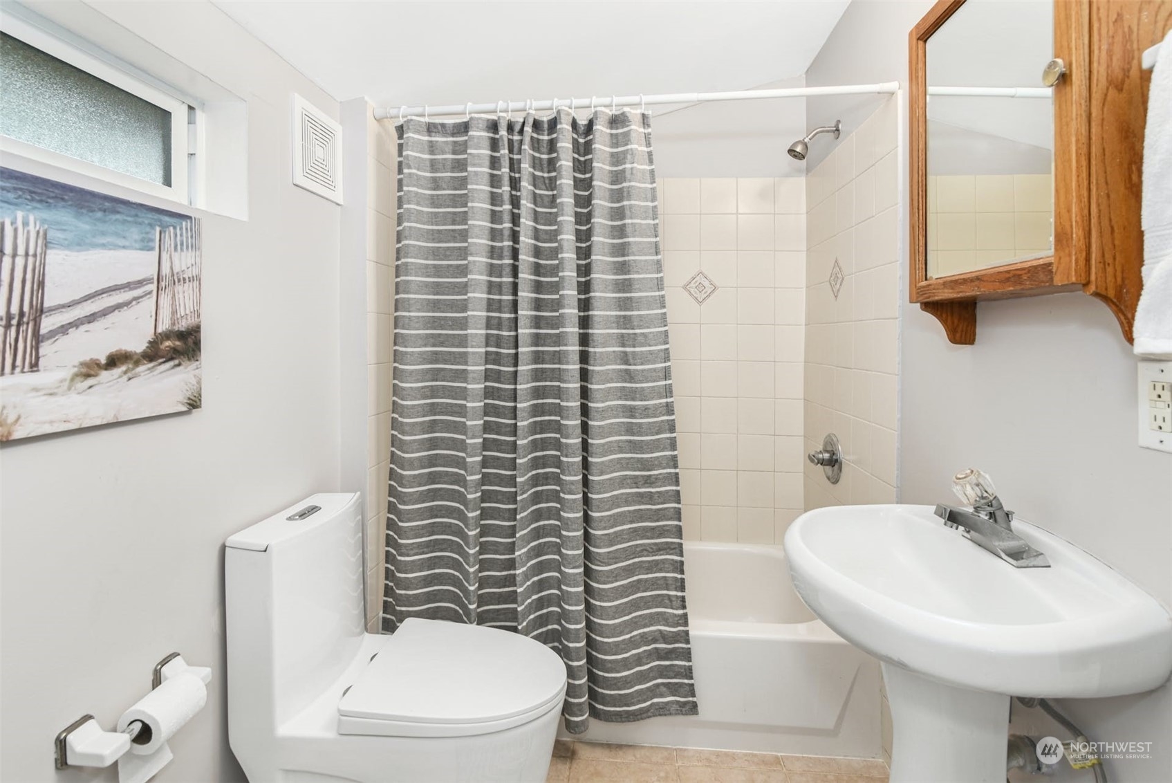 469 Maple Avenue Southwest Renton, WA 98057 - Photo 18 of 30 a bathroom with a sink a toilet and shower curtain