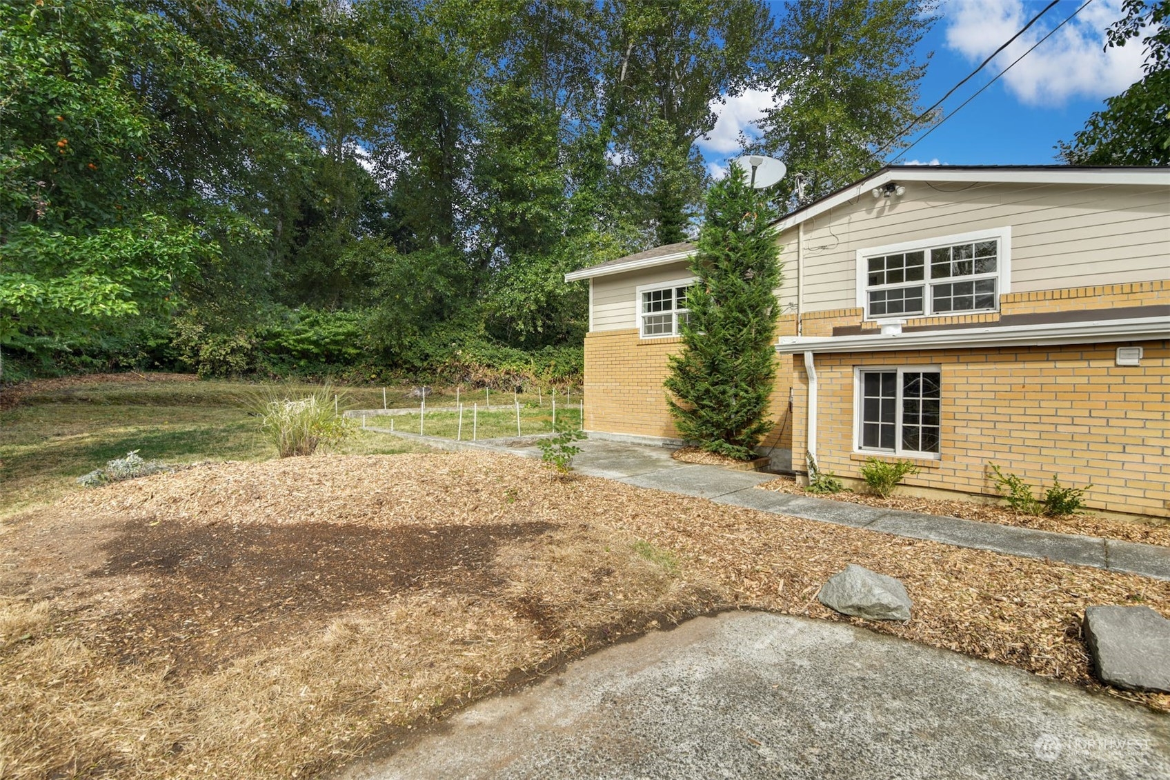 469 Maple Avenue Southwest Renton, WA 98057 - Photo 28 of 30 a view of a house with a yard and a large tree