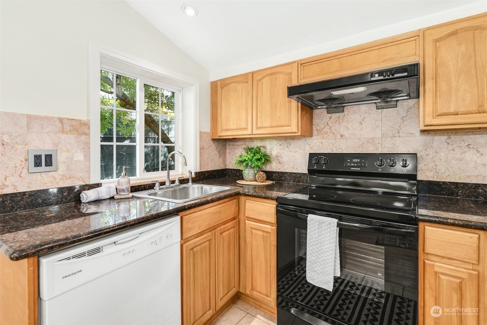 469 Maple Avenue Southwest Renton, WA 98057 - Photo 7 of 30 a kitchen with granite countertop a sink stove and cabinets