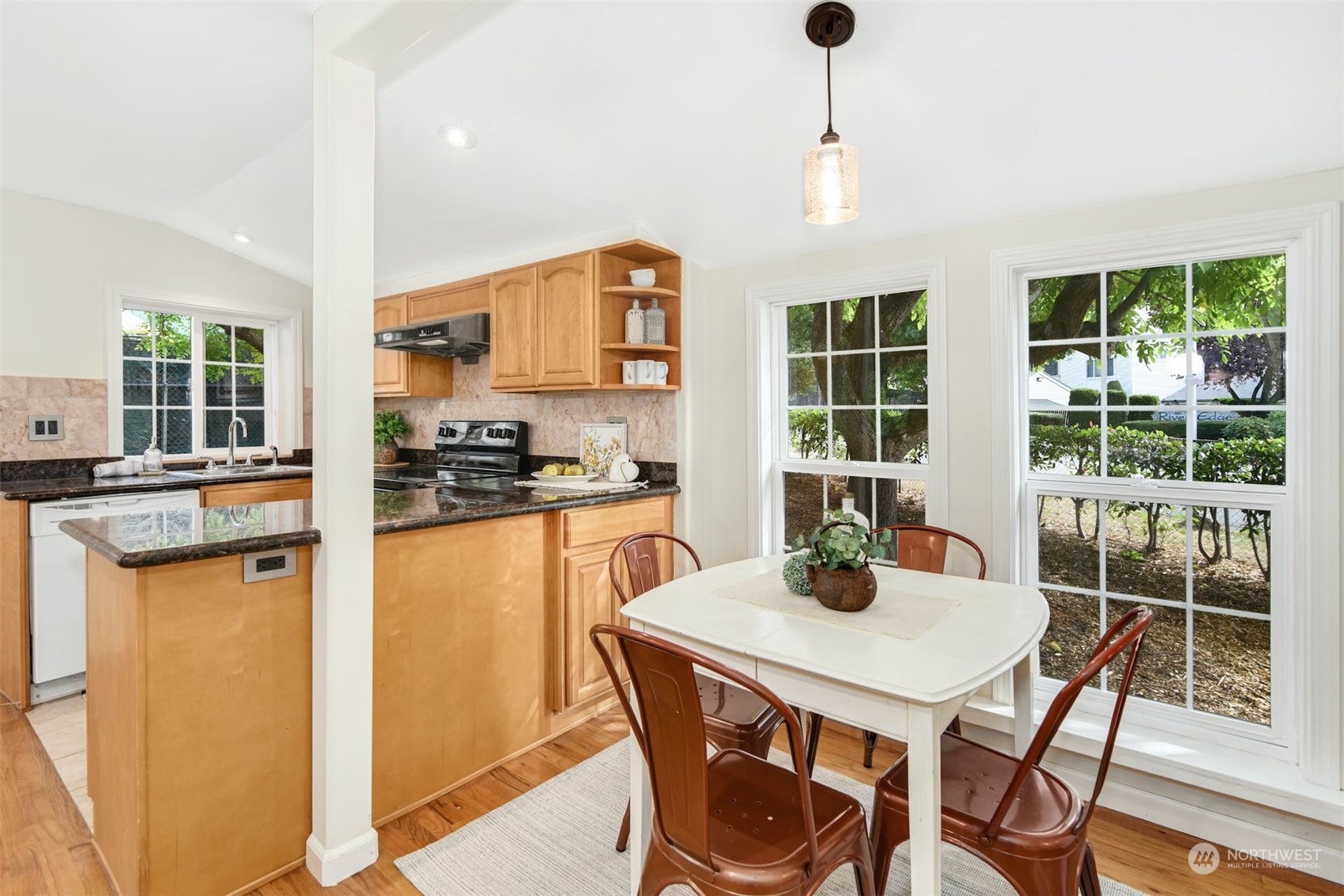 469 Maple Avenue Southwest Renton, WA 98057 - Photo 9 of 30 a kitchen with dining table and wooden floor