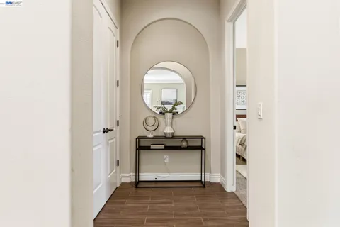 a view of walk in closet and bedroom