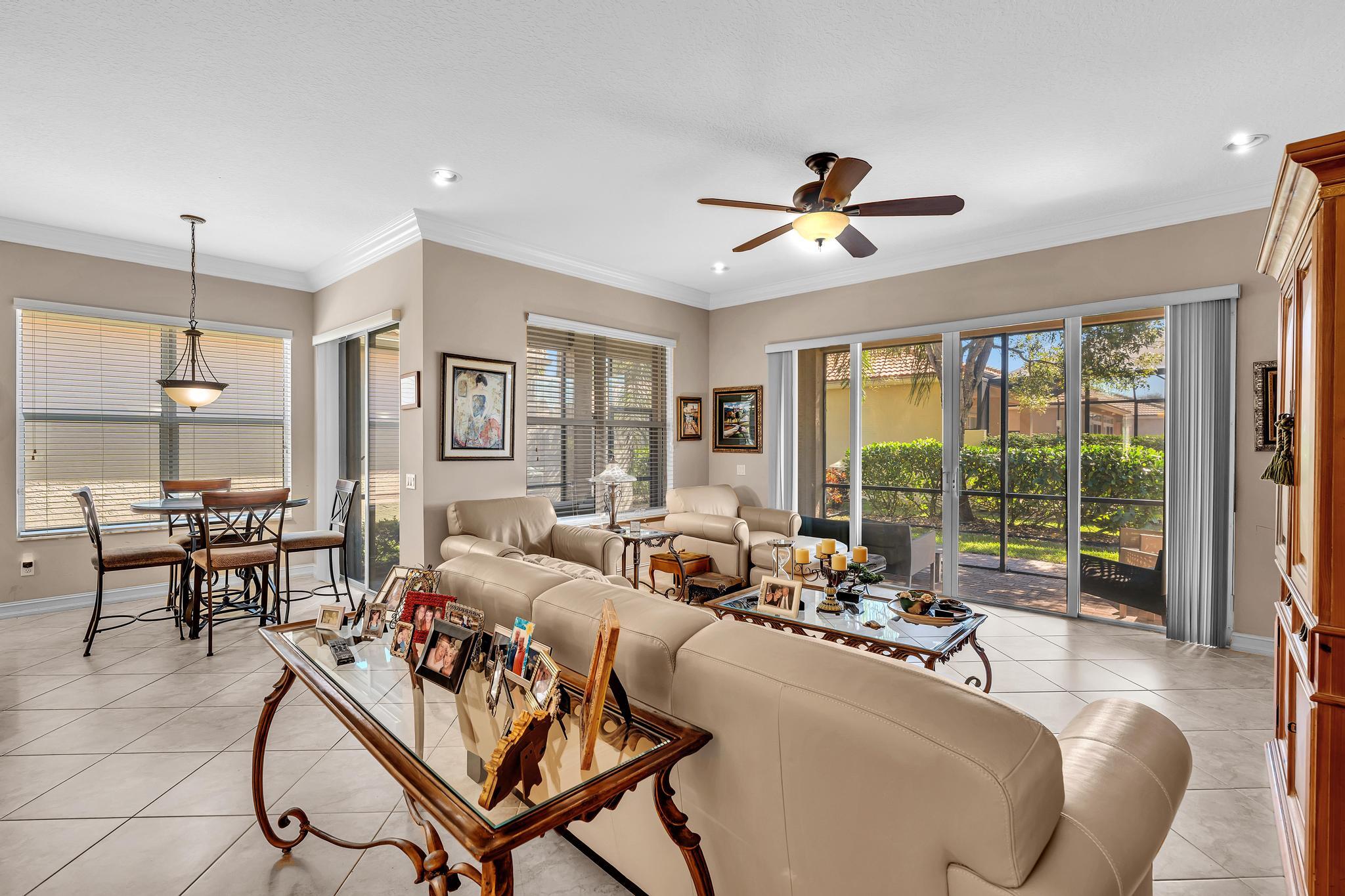 9062 Meridian View Isle Boynton Beach, FL 33473 - Photo 31 of 71 a living room with furniture ceiling fan and a window
