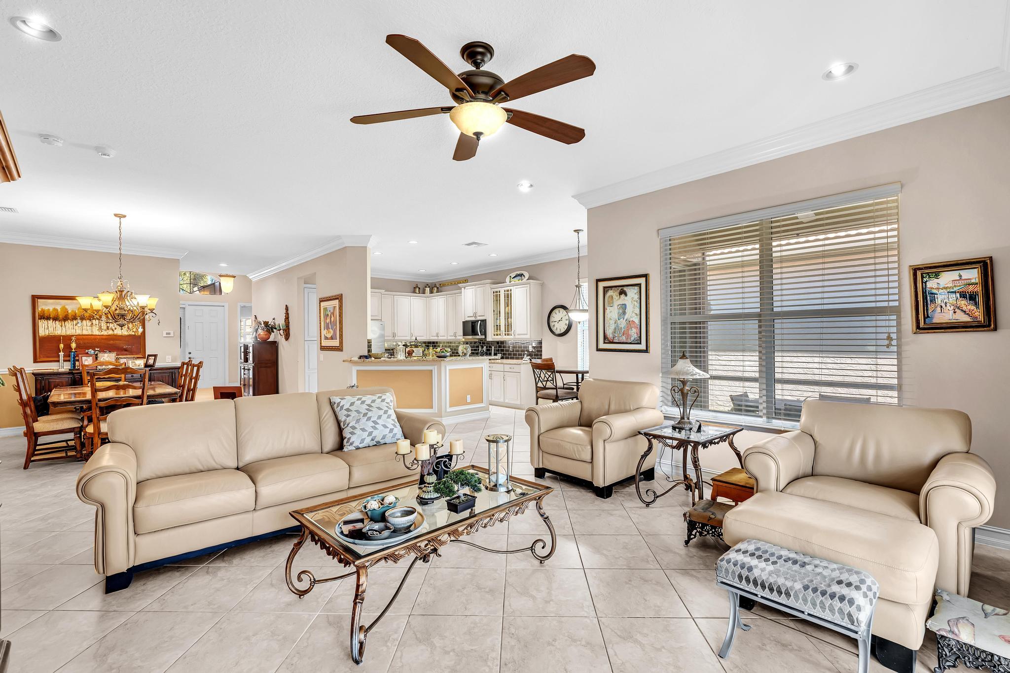 9062 Meridian View Isle Boynton Beach, FL 33473 - Photo 33 of 71 a living room with furniture ceiling fan and a window