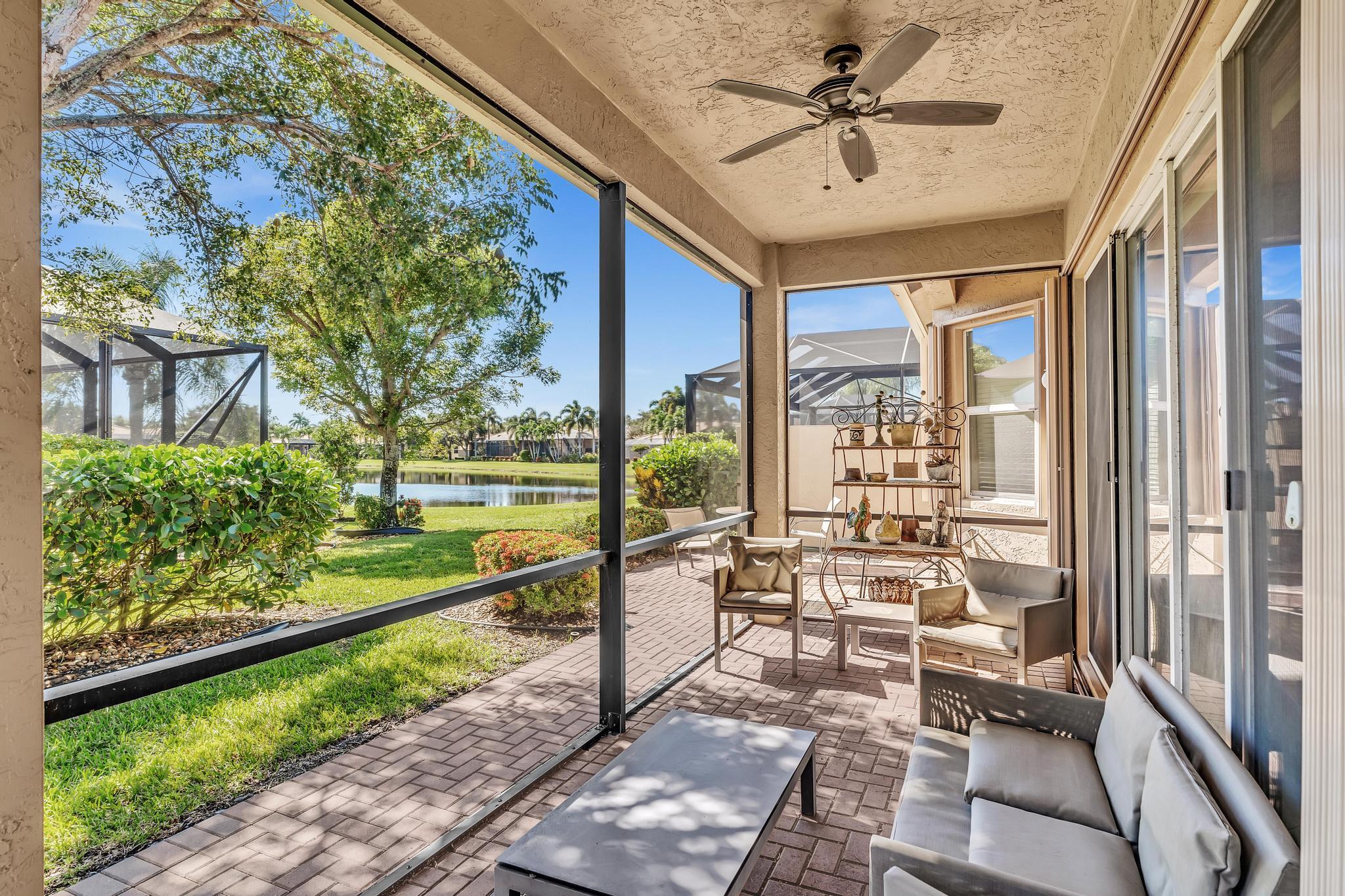 9062 Meridian View Isle Boynton Beach, FL 33473 - Photo 36 of 71 a view of a porch with furniture and a yard
