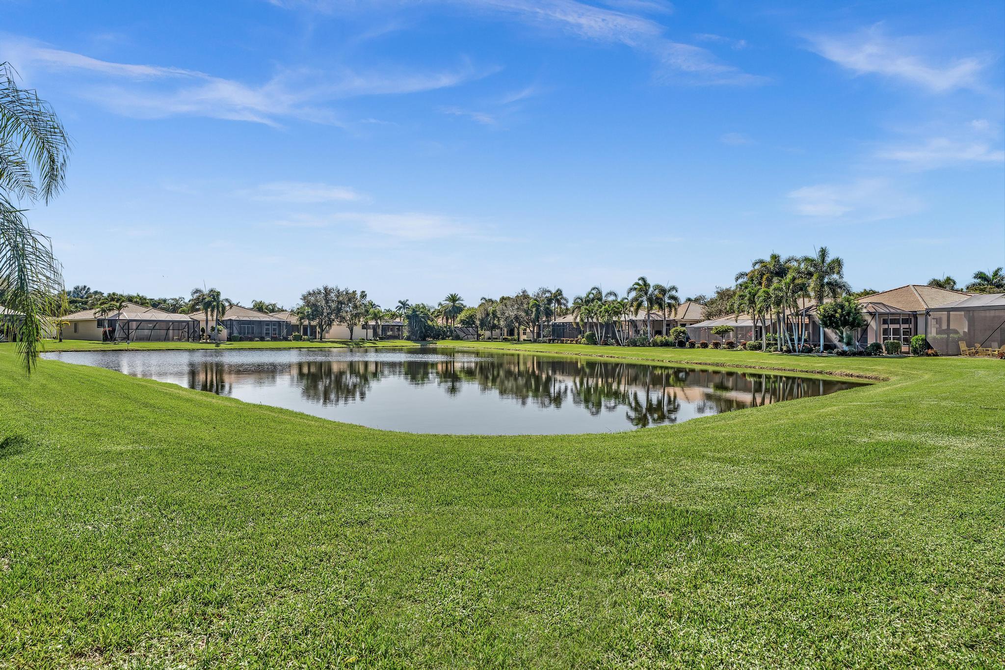 9062 Meridian View Isle Boynton Beach, FL 33473 - Photo 43 of 71 a view of a lake with houses in the back