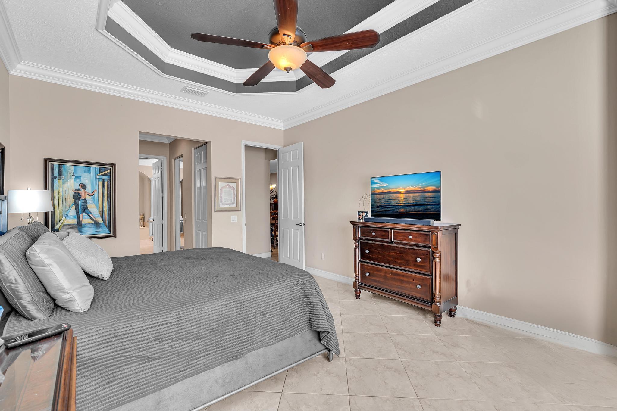 9062 Meridian View Isle Boynton Beach, FL 33473 - Photo 47 of 71 a bedroom with a bed and a television