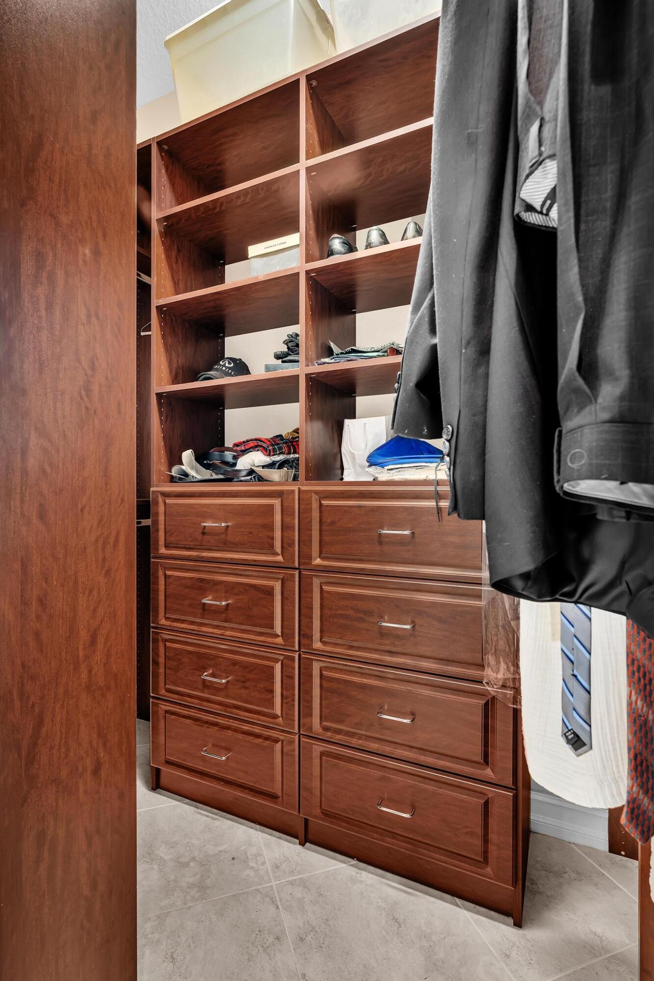 9062 Meridian View Isle Boynton Beach, FL 33473 - Photo 55 of 71 a view of walk in closet with clothes and shoes