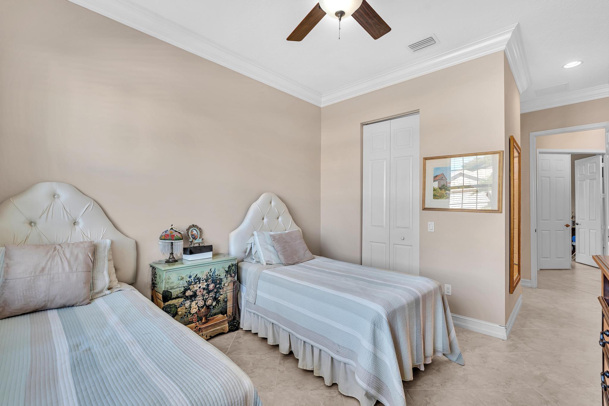 9062 Meridian View Isle Boynton Beach, FL 33473 - Photo 9 of 71 a bedroom with a bed and ceiling fan