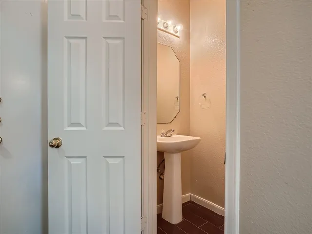 a view of a room with a ceiling fan and a window