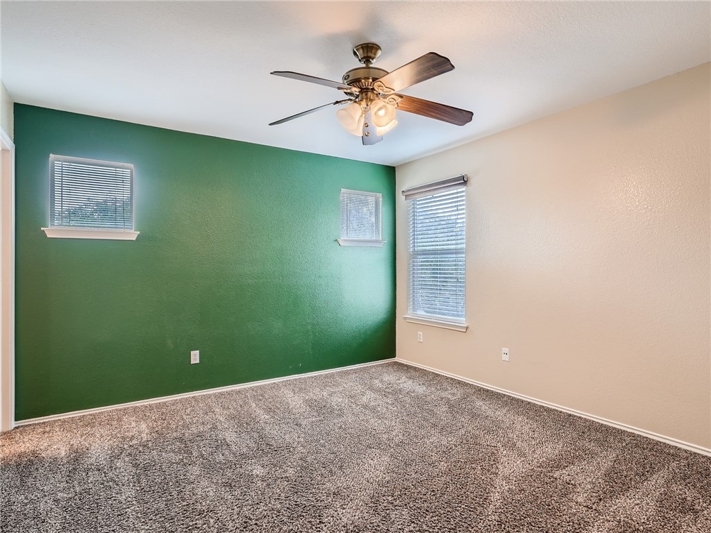 13913 Harris Ridge Boulevard, Unit B Pflugerville, TX 78660 - Photo 14 of 25 a view of a room with a ceiling fan and a window