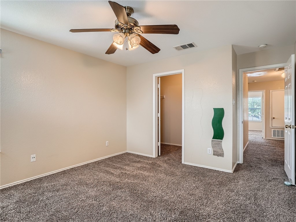 13913 Harris Ridge Boulevard, Unit B Pflugerville, TX 78660 - Photo 15 of 25 a view of a room with wooden floor and a ceiling fan