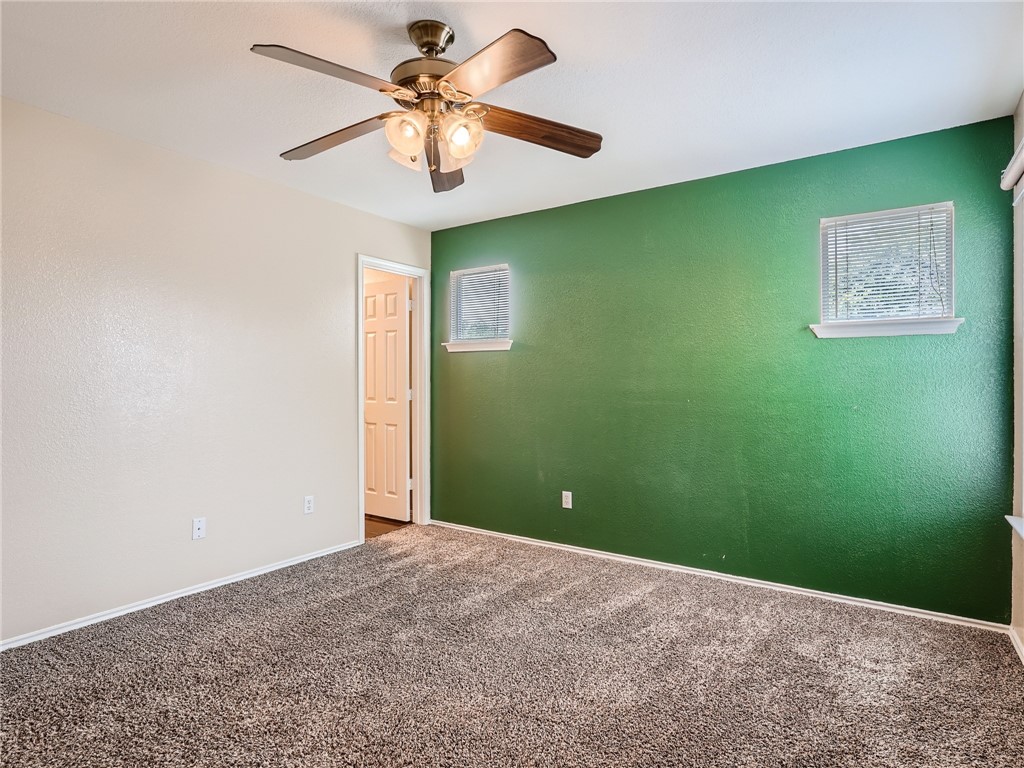 13913 Harris Ridge Boulevard, Unit B Pflugerville, TX 78660 - Photo 16 of 25 an empty room with a fan and a window