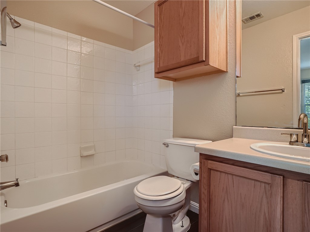13913 Harris Ridge Boulevard, Unit B Pflugerville, TX 78660 - Photo 18 of 25 a bathroom with a sink a toilet and bathtub