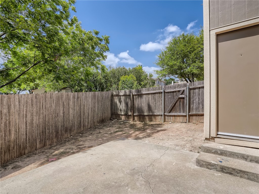 13913 Harris Ridge Boulevard, Unit B Pflugerville, TX 78660 - Photo 23 of 25 a backyard of a house with table and chairs