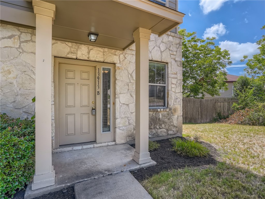 13913 Harris Ridge Boulevard, Unit B Pflugerville, TX 78660 - Photo 3 of 25 front view of a house with a glass door