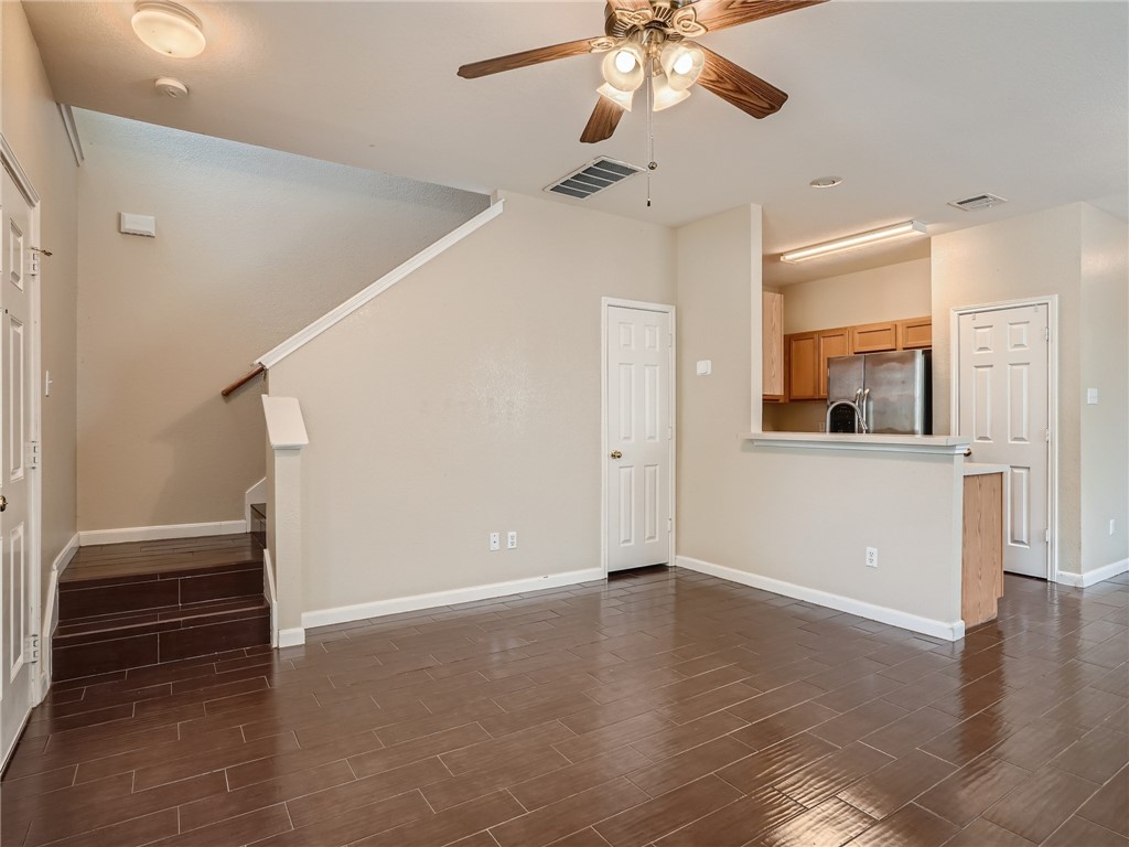 13913 Harris Ridge Boulevard, Unit B Pflugerville, TX 78660 - Photo 4 of 25 wooden floor in an empty room with a window