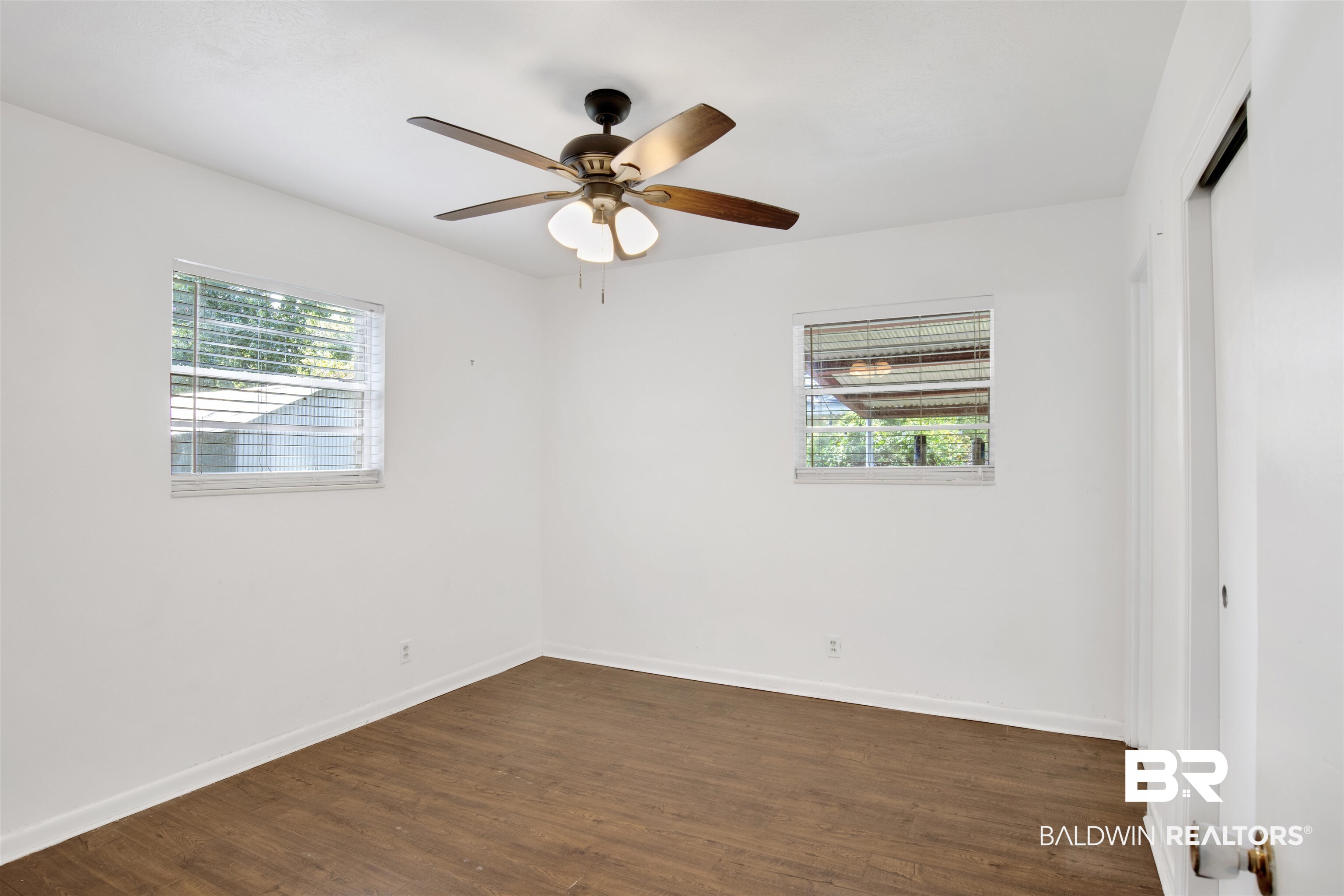 2 Lee Circle Daphne, AL 36527 - Photo 13 of 21 Unfurnished room featuring ceiling fan and dark hardwood / wood-style flooring