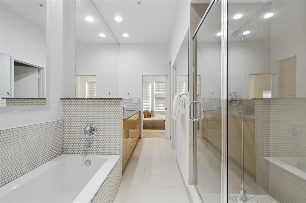 2111 Clark Street, Unit H Dallas, TX 75204 - Photo 11 of 37 a bathroom with a tub shower vanity and a sink