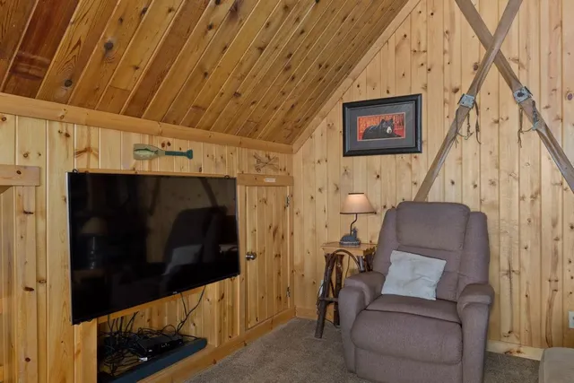 a living room with furniture a flat screen tv and windows