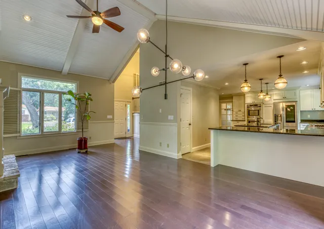 a view of a room with wooden floor and a window
