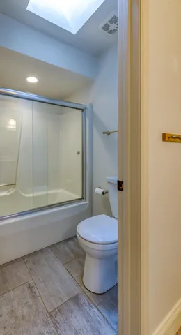 a bathroom with a toilet and a shower