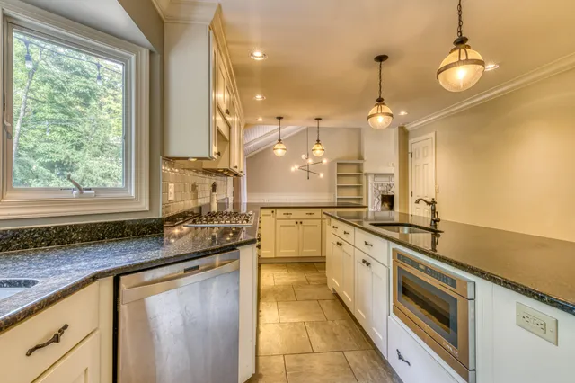 a large kitchen with a sink and stove