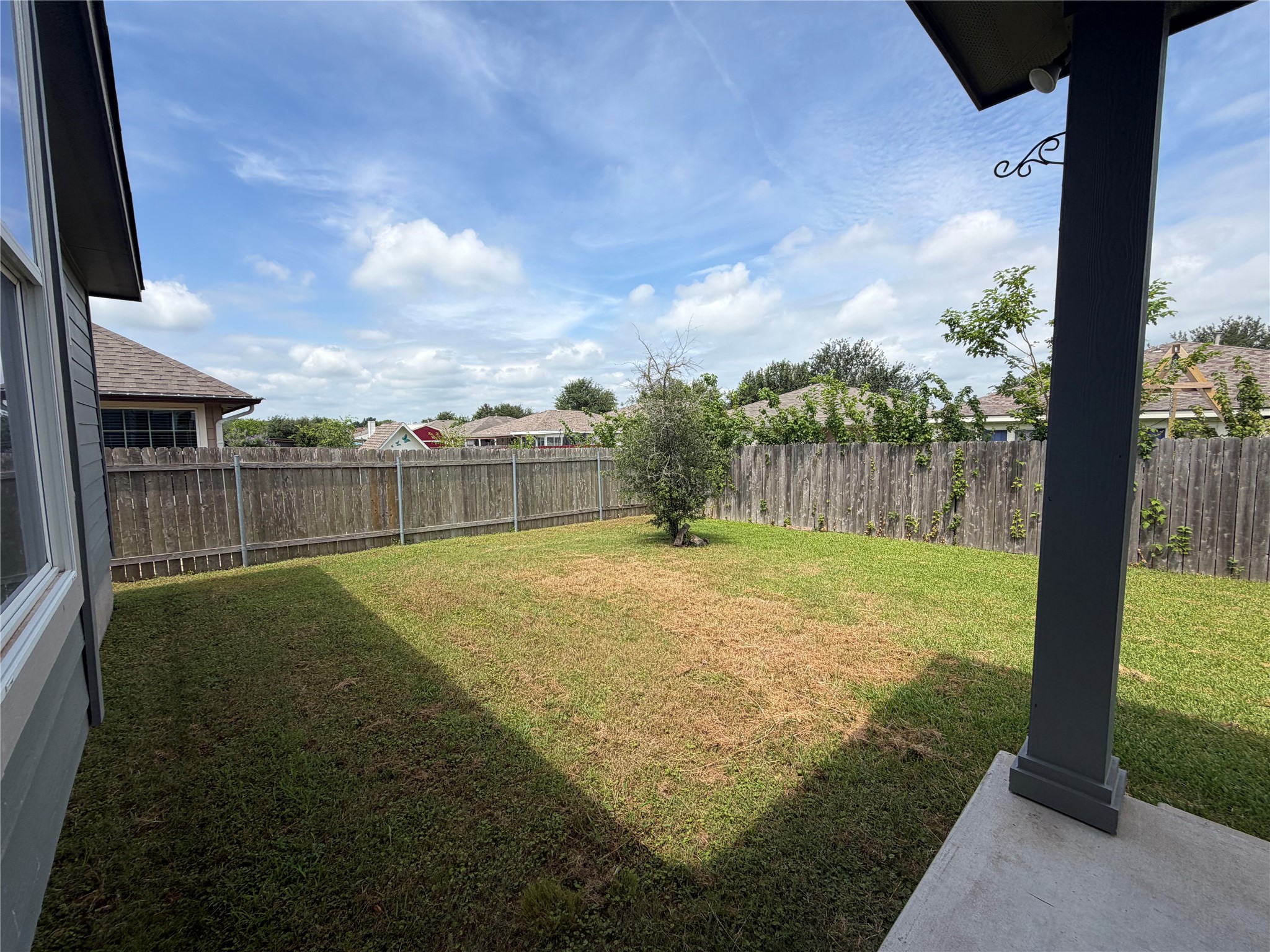 419 Gettysburg Loop Elgin, TX 78621 - Photo 19 of 21 A well-maintained wooden fence encloses this private yard, offering a secure outdoor space.