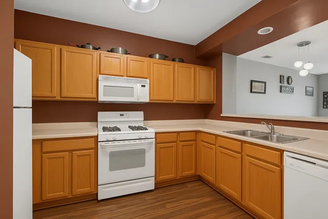 a kitchen with a stove sink and cabinets