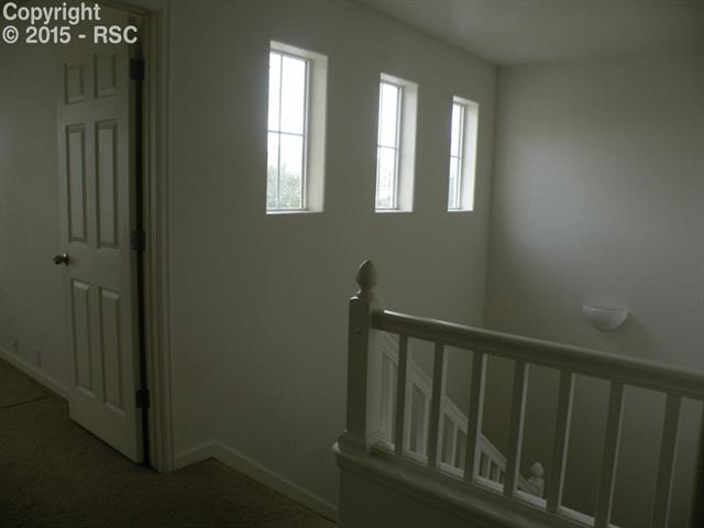 4012 Diamond Ridge View Colorado Springs, CO 80918 - Photo 9 of 15 Beautiful windows and staircase from upper landing.