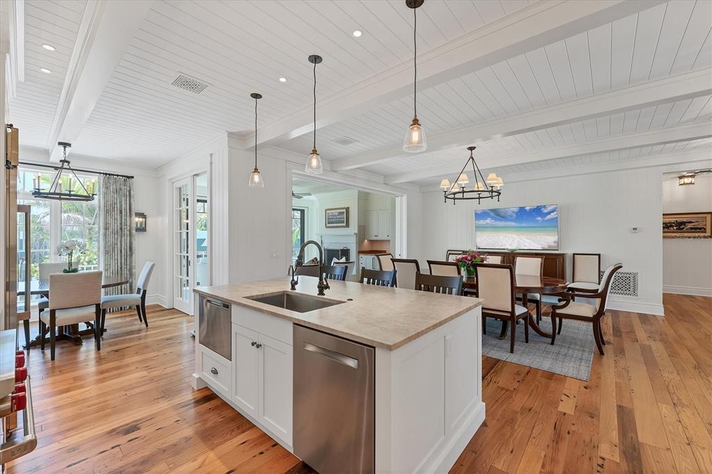 150 1st Street East Boca Grande, FL 33921 - Photo 12 of 72 a view of a dining room and livingroom with furniture wooden floor a chandelier