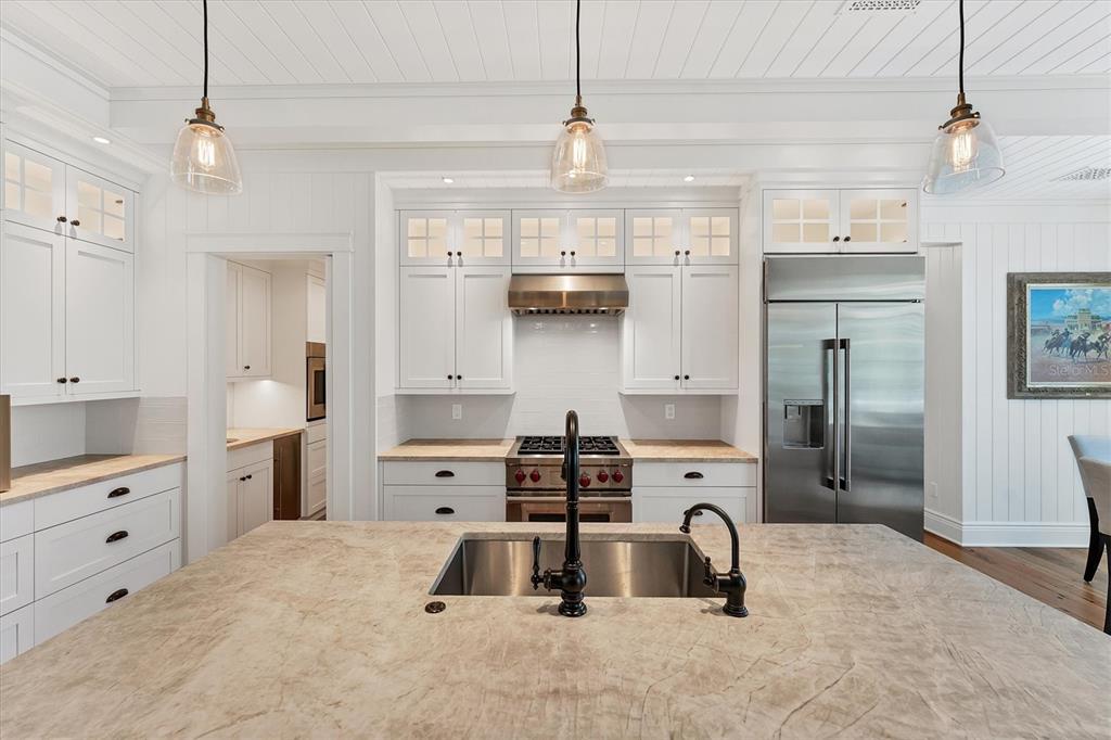 150 1st Street East Boca Grande, FL 33921 - Photo 14 of 72 a kitchen with stainless steel appliances a sink stove and refrigerator