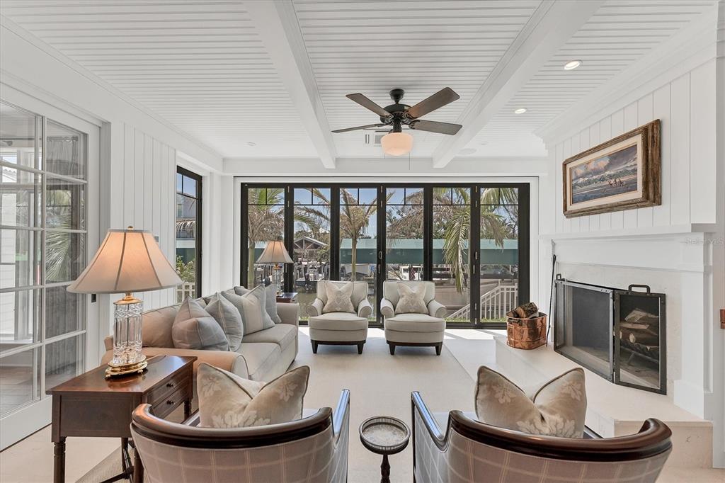 150 1st Street East Boca Grande, FL 33921 - Photo 18 of 72 a living room with furniture a fireplace and a large window